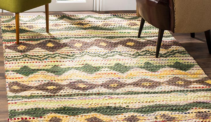 A clean area rug placed on a hardwood floor in a living room