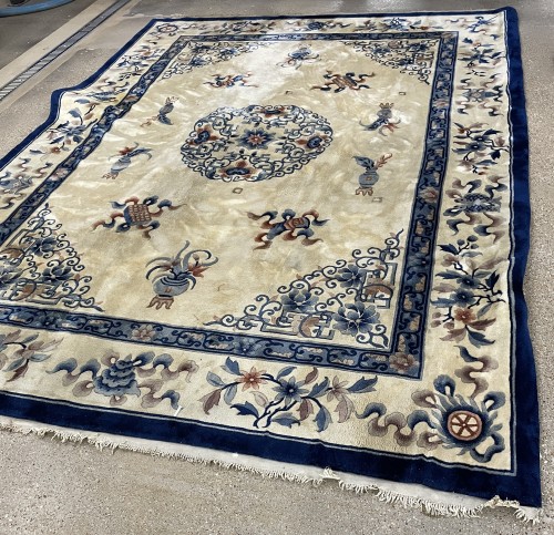 Beautifully cleaned commercial oriental rug with cream background and blue floral patterns, looking vibrant after professional rug cleaning by Dalworth.